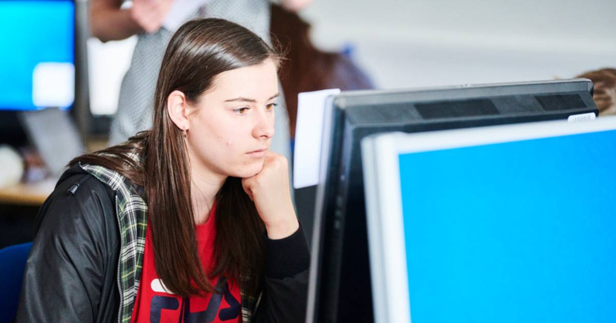 A Newcastle student sat thinking in front of a computer